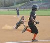 Haley Day pitches the ball to first as she’s going down, but Burton’s A’nyah Hollinger outruns the throw. PHOTO BY KELLEY PEARS