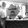 <p>Appalachia Town Manager Fred Luntsford holds one of the 25 signs being posted on all roads leading into town and roads leading into neighborhoods within the corporate limits. The term 'RVs on roadways' refers to the town's ordinance permitting vehicles such as four-wheelers or golf carts, when used within the town limits, to be driven as recreation vehicles at 25 miles an hour or less on town streets. Clerk/Treasurer Michele Hylton sits at the front desk where 'RV' decals are being sold at $20 each, after receipt of proof of inspection.</p>