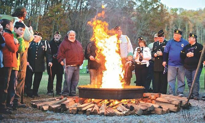 Local veterans commit retired flags to the flames. 

MICHELLE MULLINS PHOTO