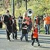 Youngsters and a few grownups show their Raider pride as they walk to musical accompaniment by the J.I. Burton High School band. FRED RAMEY PHOTO.