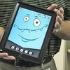 Assistive technology team member Mark Giles holds an iPad, featuring one of the many colorful, animated figures in an application that is changing the way teachers teach and children learn. JENAY TATE PHOTO.Click Hereto order photo reprints
