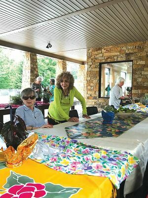 Beverly Viers and Phyllis Hatcher prepare the tables for the meeting.