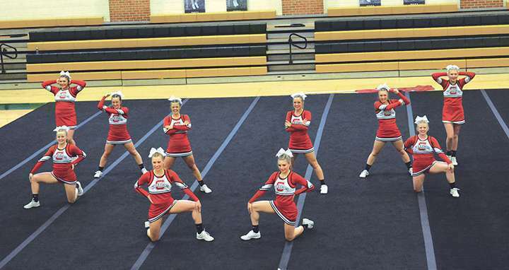 The Lady Warrior competition cheer team strikes a pose during their only regular season competition. SUBMITTED PHOTO