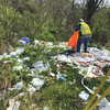 A Great American Cleanup volunteer cleans up a spot in Norton where bears haul pilfered bags of trash for their dinner.  SUBMITTED PHOTO