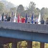 The group displays the colors on the bridge. The annual tribute is known as ‘Flags Over 58.’