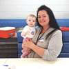 Future voter Amelia Love cozied up Tuesday with Peggy Stanley, chief electoral officer for the South Coeburn voting precinct, during the presidential primary election.  TRACEY SALYERS PHOTO