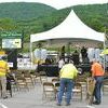 Norton workers set up chairs Wednesday afternoon for a Best Friend Festival concert while hoping the intermittent rain showers would hold off awhile. Unfortunately, the nasty weather is expected to continue today and part of Saturday.  JEFF LESTER PHOTO