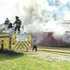City firefighters scramble as smoke billows from the former Red Barn building, also known as Bargain Barn.  NORTON FIRE DEPARTMENT PHOTO