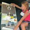 A young girl shows off a Wise County Sheriff’s Office calendar obtained Thursday during a National Night Out event.  LISA MAINE PHOTO