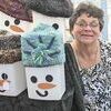 Becky Beavers of Dungannon cozies up to snowmen wearing hand-knit hats she makes along with friends Jeanne Mullins and Sarah Mullins of Wise. The trio’s handiwork of hats, scarves and fine quilts filled their booth at the Wise Fall Fling Saturday, where Sarah also spun her own yarn. JENAY TATE PHOTO.Click Hereto order photo reprints