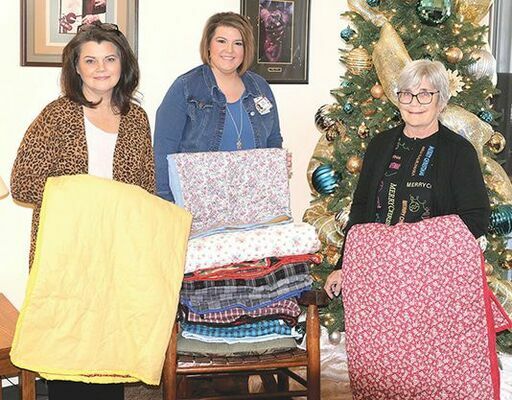 Hannah Bolling (center) with Community Physicians Oncology, Norton, visited MEOC’s main office in Big Stone Gap Dec. 12 to collect nine lap blankets lovingly handstitched by Pound Senior Community Site participants. The blankets will be included in care packages for local cancer patients. With Bolling are MEOC Nutrition Services Director Carrie Stallard (left) and Mountain Laurel Cancer Support &amp; Resource Center Coordinator Dianne Morris.