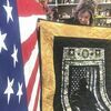 At The Fabric House Saturday, owner and veterans quilt project organizer Susan Downs-Freeman pauses to look at one of the veterans' gifts — an Army Silhouette lap quilt — as she prepared for Veterans Day presentation ceremonies Monday.

JENAY TATE PHOTO