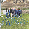 The Norton Department of Social Services and Commonwealth Catholic Charities, along with city youth, decorated the community with pinwheels Friday to mark the beginning of Child Abuse Prevention Month. Pictured are department and charity employees flanking, left to right, Hallie and Ezra.  ABE RUTHERFORD PHOTO