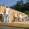 Volunteers raise the frame Saturday on the Habitat for Humanity house under construction in the Southern section.