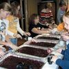 A group of young volunteers helps load cranberry sauce from pans to individual serving containers in preparation for the annual Norton Community Thanksgiving meal event. SUBMITTED PHOTO.