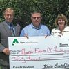 Displaying the donation from Alpha Natural Resources are, left to right, Dr. Scott Hamilton, president of Mountain Empire Community College; Donnie Ratliff, vice president for external relations for Alpha Natural Resources; and Donna Stanley, executive director of the MECC Foundation.